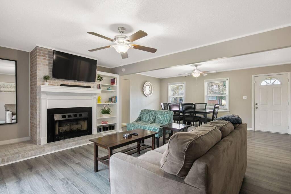 a living room with a couch and a fireplace at Mesa Manor in Fayetteville