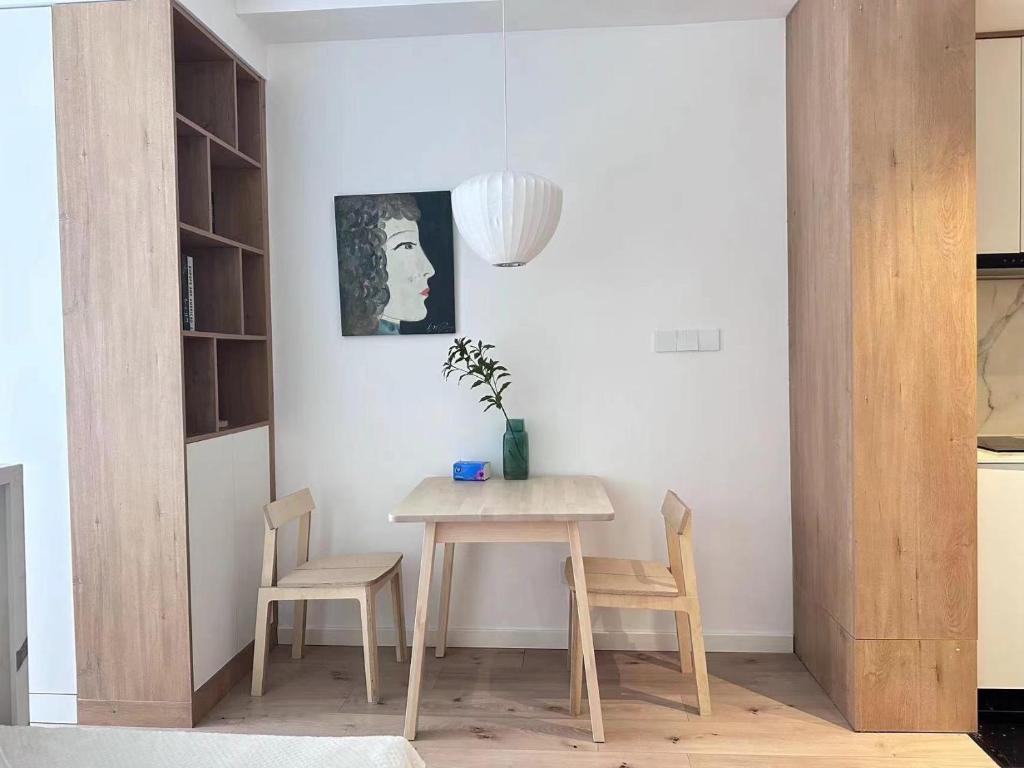 a dining room with a table and two chairs at 同济佳苑公寓 in Shanghai