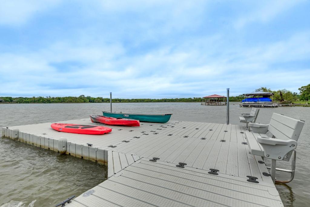 a dock with three boats on the water at Family-Friendly Alvarado Lake Home with Kayak, Canoe in Alvarado