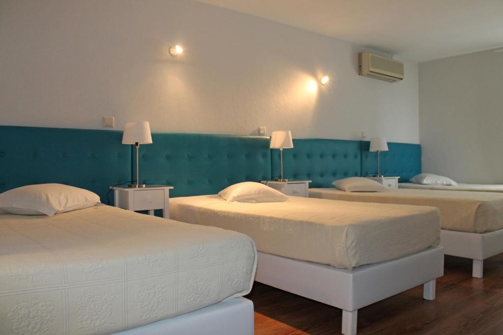 Uma cama ou camas num quarto em Hotel Porto Nobre