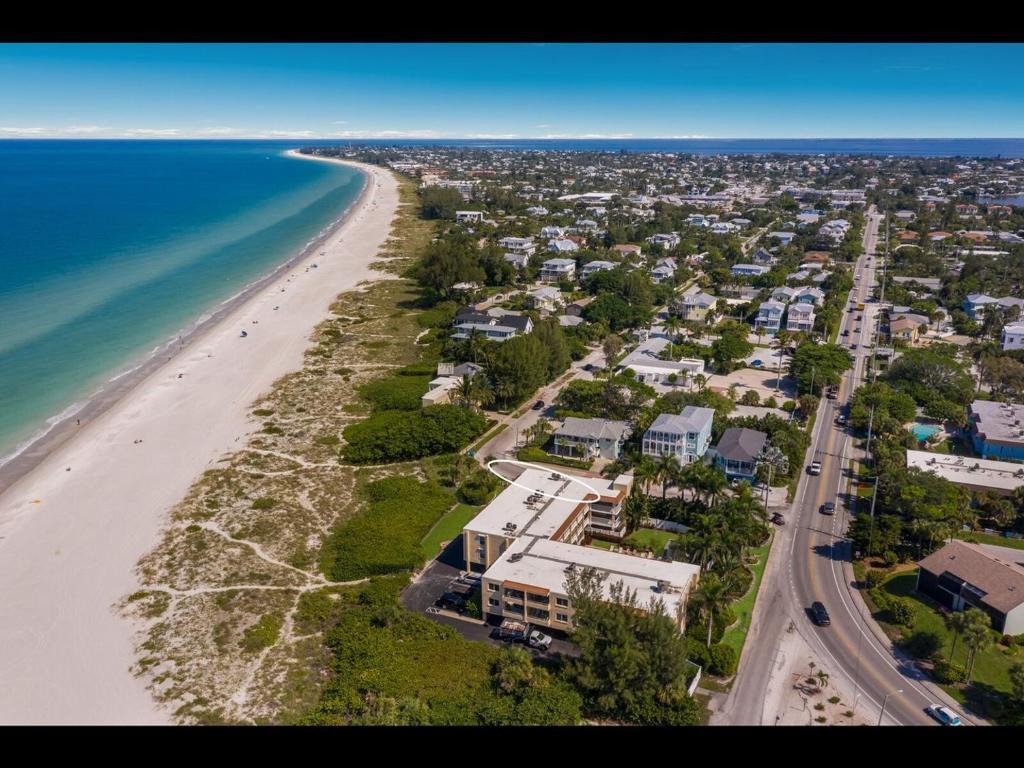 an aerial view of a beach with houses and the ocean at 4200 GULF DRIVE UNIT 108 home in Holmes Beach