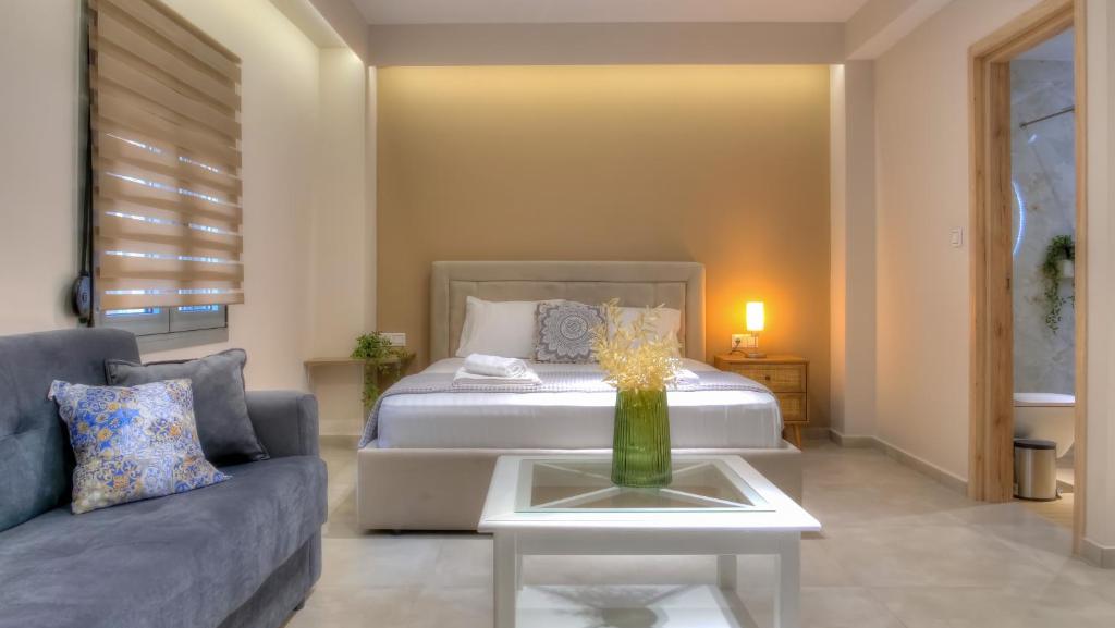 a living room with a bed and a couch at Loutsiana Apartments Corfu in Alykes Potamou