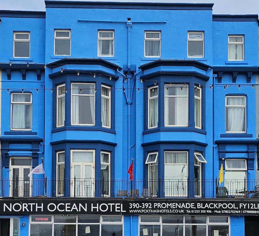 a blue building with a sign for the north ocean hotel at North Ocean Hotel in Blackpool