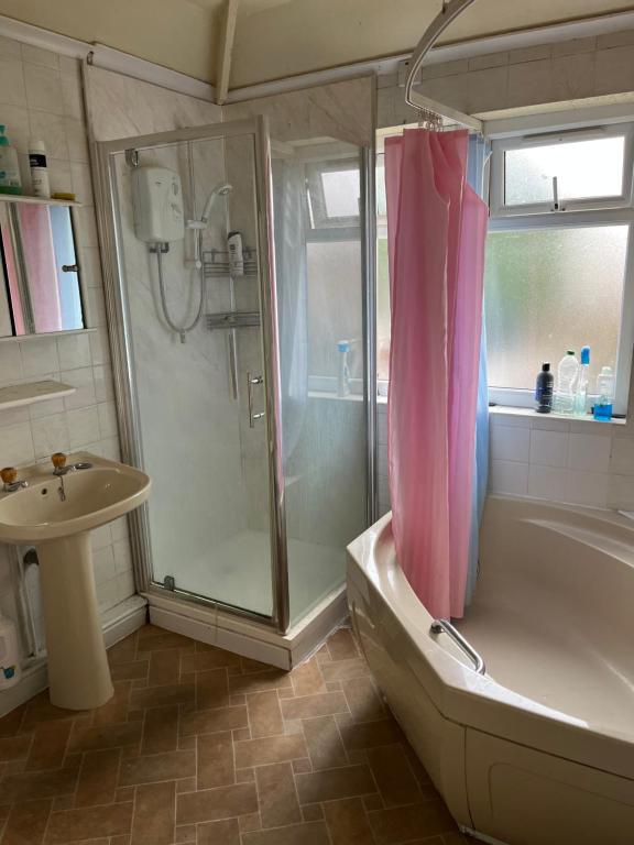 a bathroom with a shower and a tub and a sink at Leicester UK Room 2 Edward House in Leicester