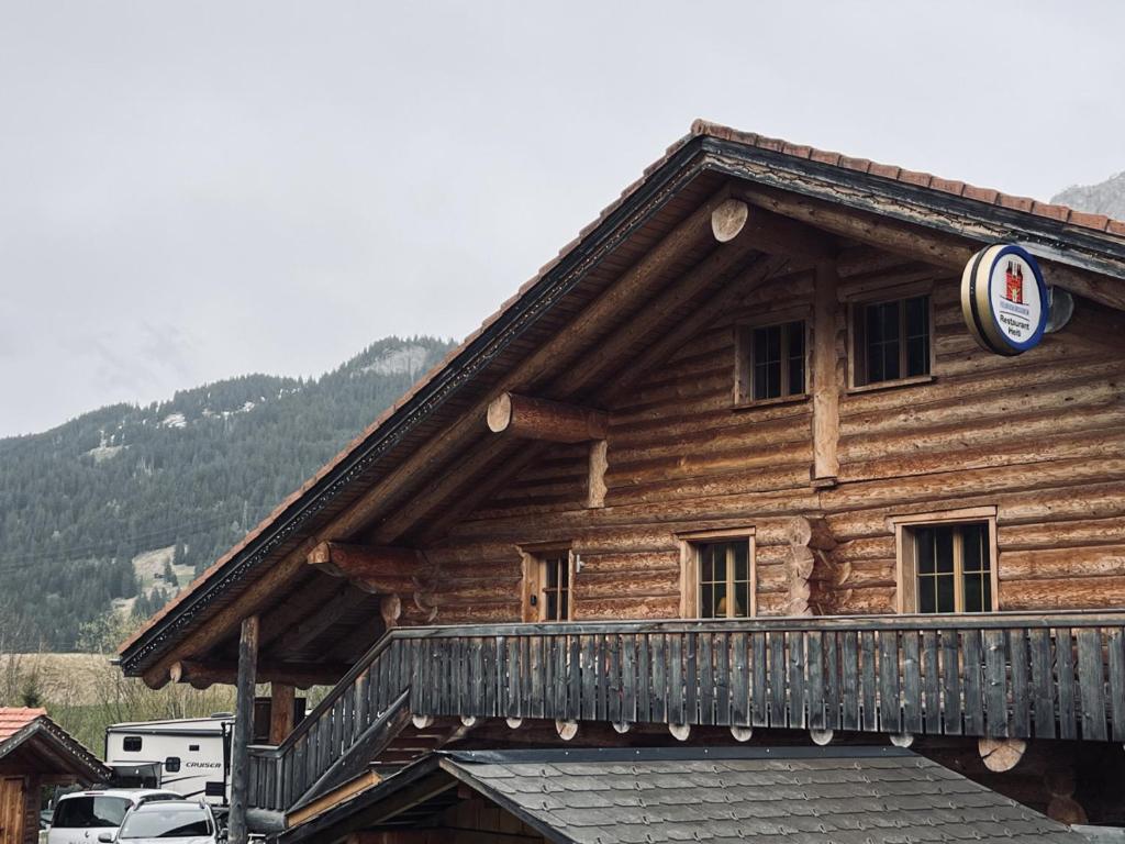 a log cabin with a balcony on top of it at 0 Simple - The Heiti Lodge in Gsteig