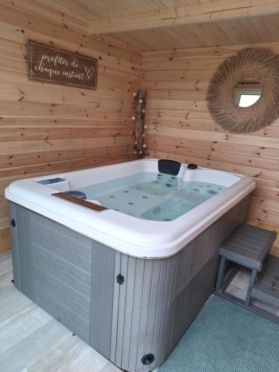 una bañera de hidromasaje en una cabaña de madera en LAlexandrie, en Régusse