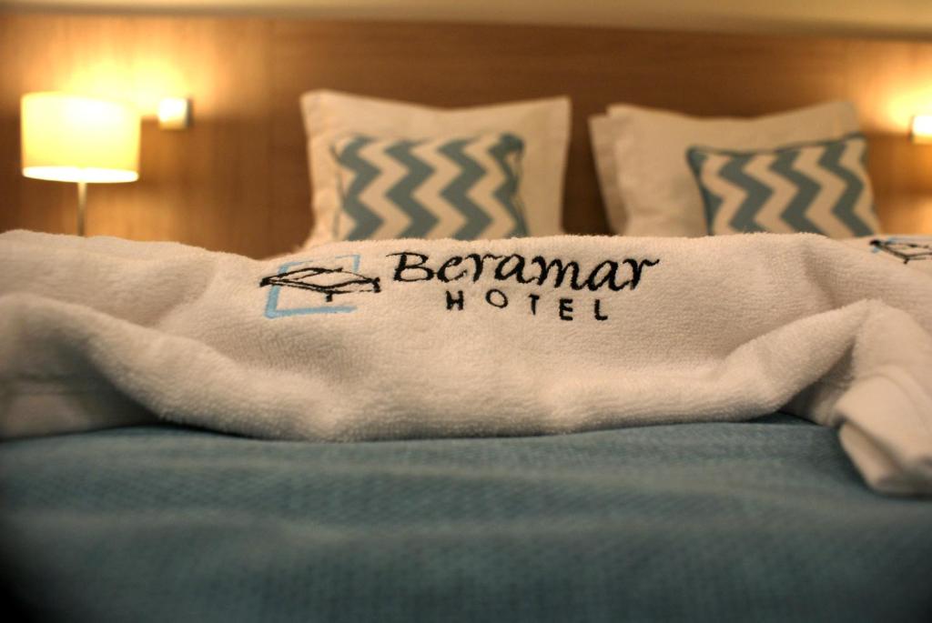 a bed with a towel with the words bennington motel at Beramar Hotel in Praia