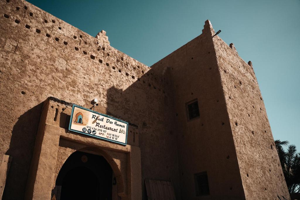 a building with a sign on the side of it at Dar Haroun in Rissani