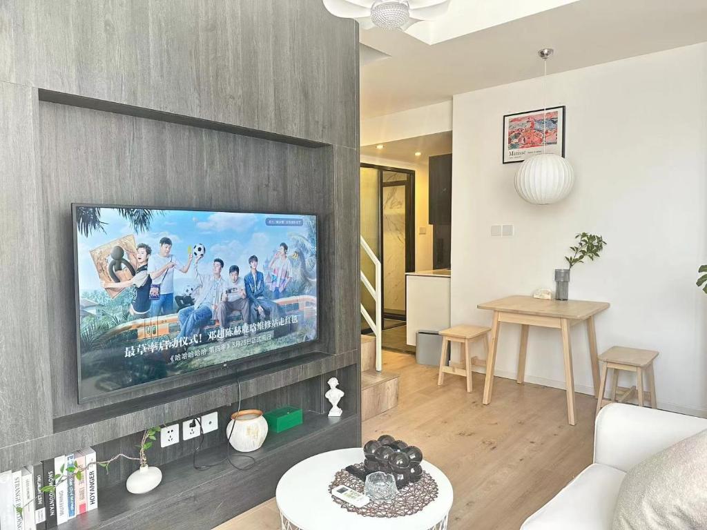 a living room with a flat screen tv on a wall at 同济佳苑公寓 in Shanghai