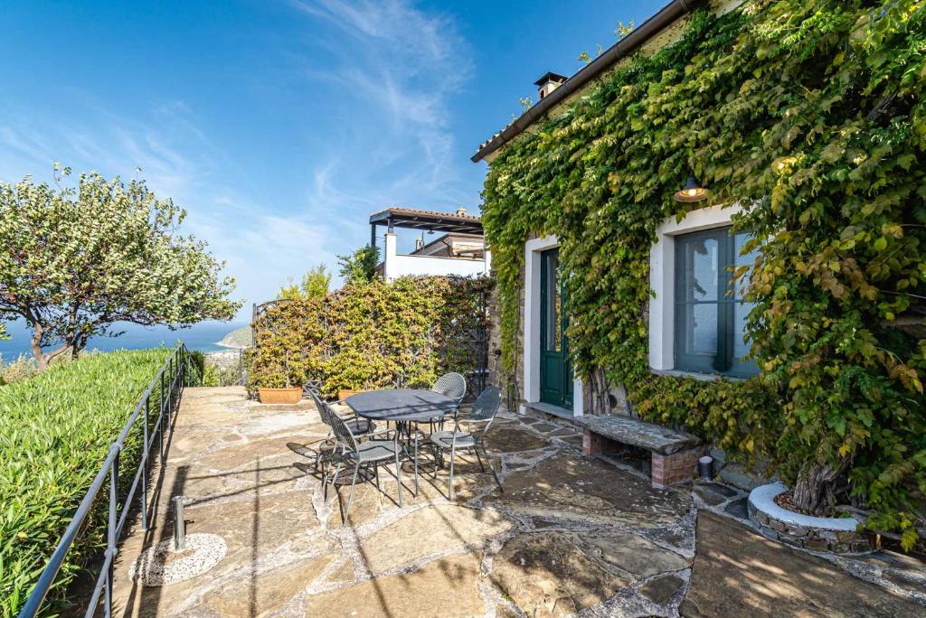 a patio with a table and chairs next to a building at La Casettina del Forno in Santa Maria di Castellabate