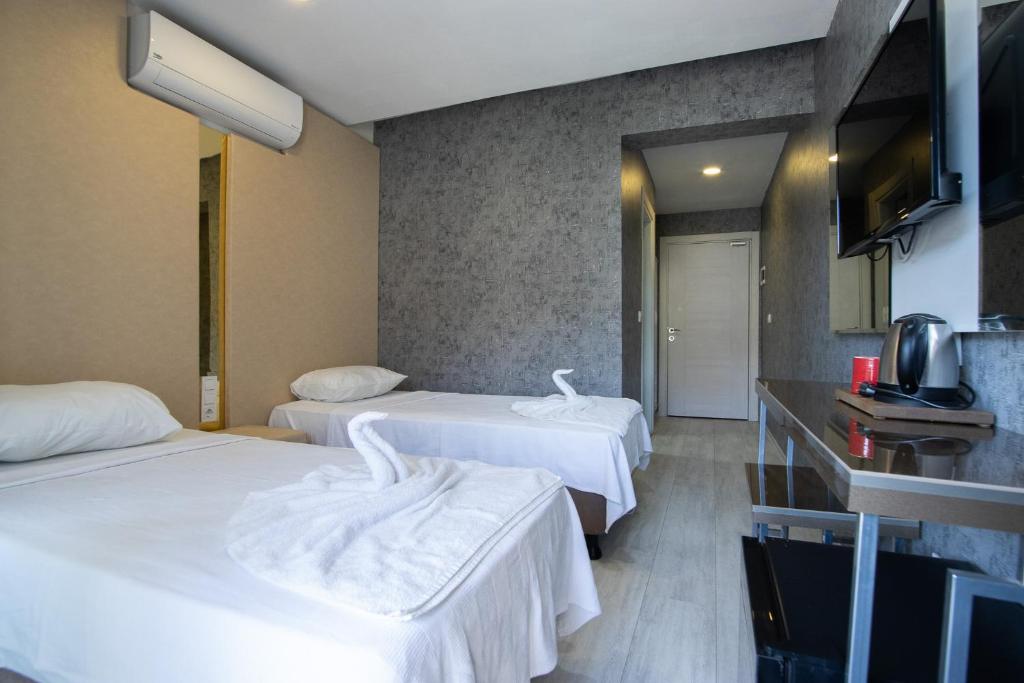 Postel nebo postele na pokoji v ubytování Emilia Otel