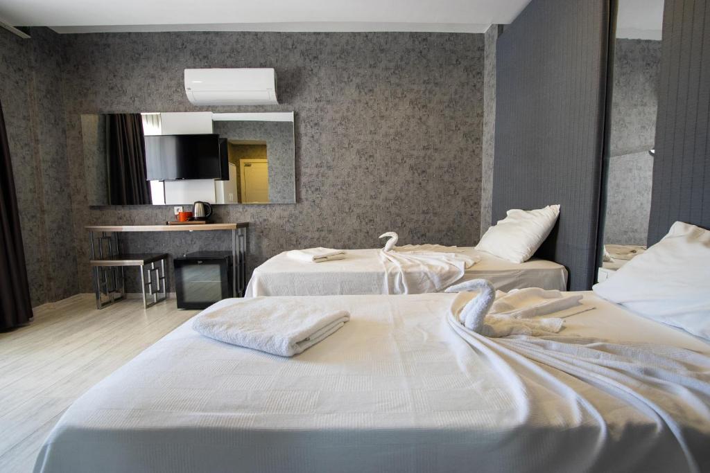 Postel nebo postele na pokoji v ubytování Emilia Otel
