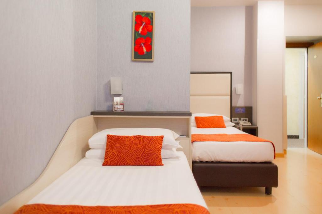 Postel nebo postele na pokoji v ubytování Hotel Piacenza