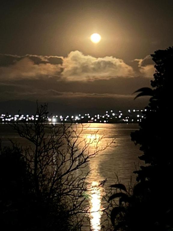a moon rising over a body of water at night at Vista Alago in Villa Ciudad Parque