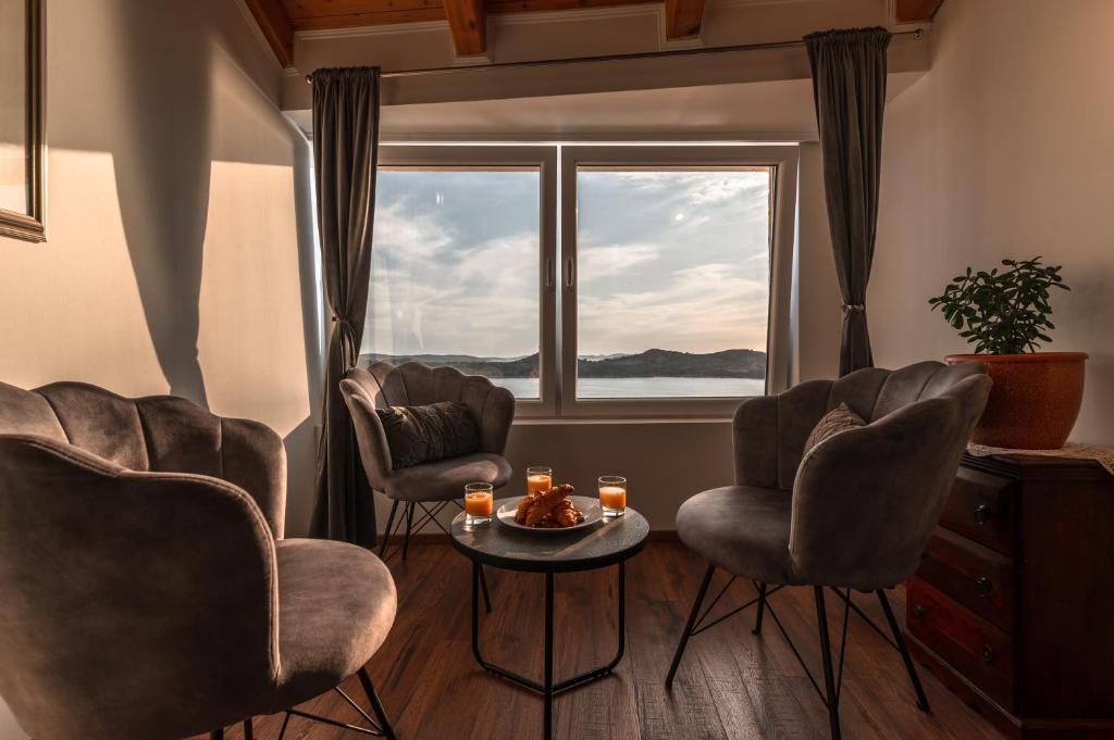 a room with three chairs and a table and a window at Villa Old Town in Šibenik