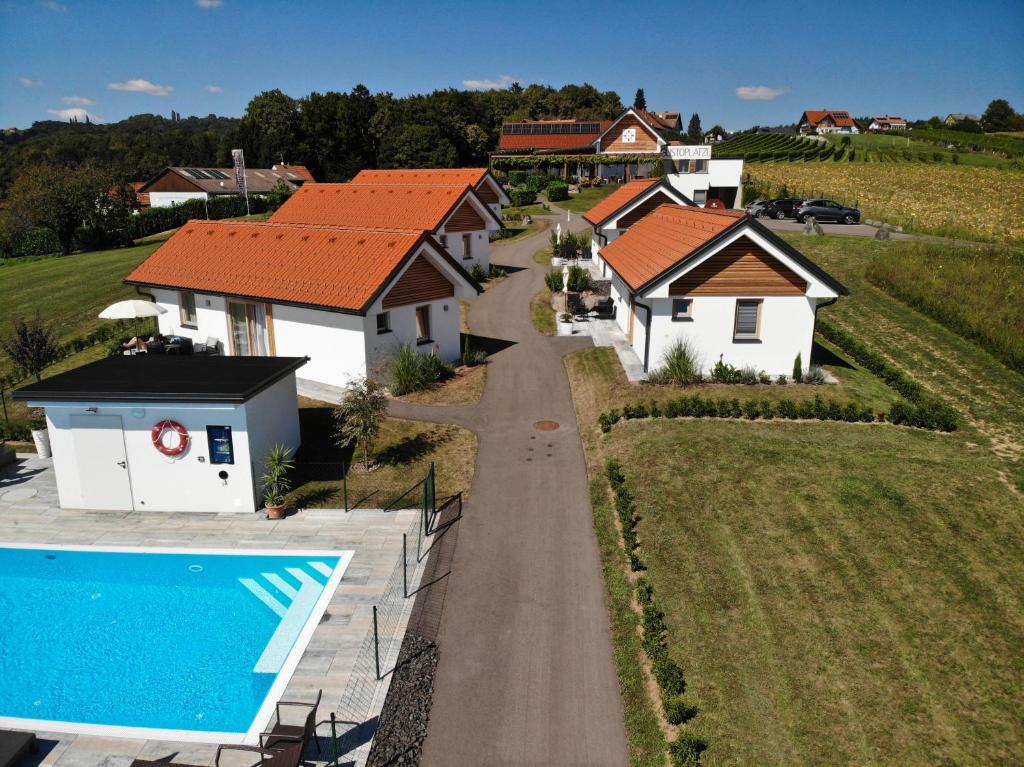 an aerial view of a house with a swimming pool at Gusto Lodges in Klöch