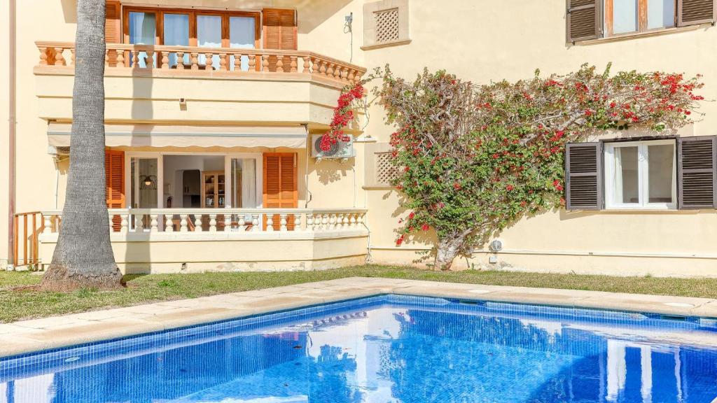 a house with a swimming pool in front of a house at Cordonyer in Port de Pollensa