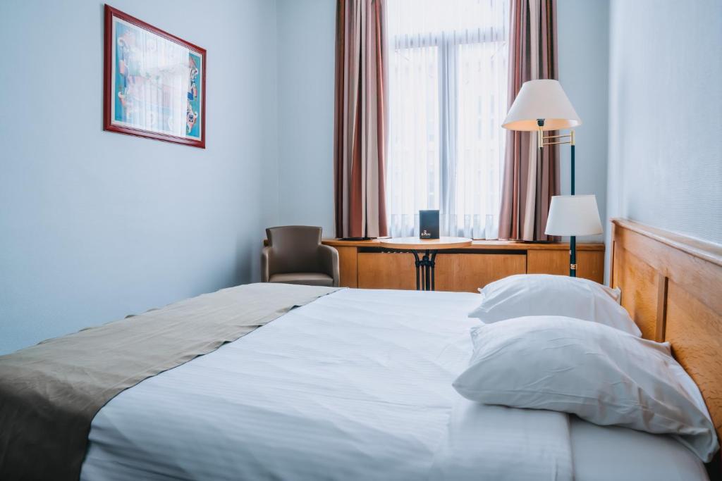 Postel nebo postele na pokoji v ubytování Hotel Les Eleveurs