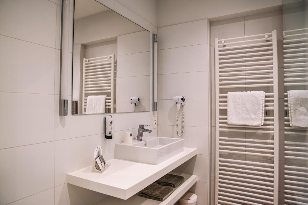 Koupelna v ubytování Hotel Les Eleveurs
