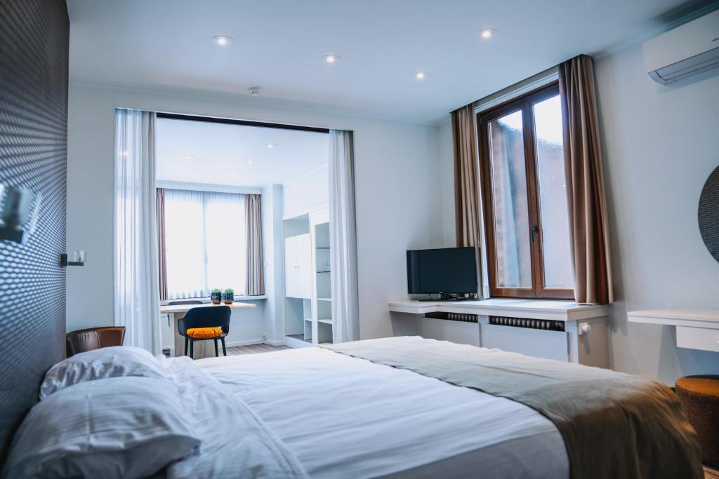 Postel nebo postele na pokoji v ubytování Hotel Les Eleveurs
