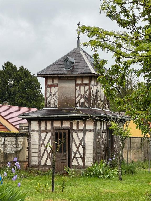 an old wooden building with a tower on top of it at gite de saint lye in Saint-Lyé