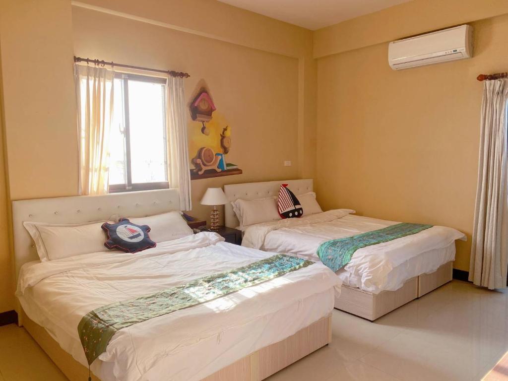 Postel nebo postele na pokoji v ubytování 澎湖藍海會館Blue Ocean Inn Penghu