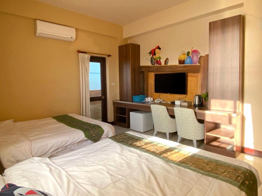 Postel nebo postele na pokoji v ubytování 澎湖藍海會館Blue Ocean Inn Penghu