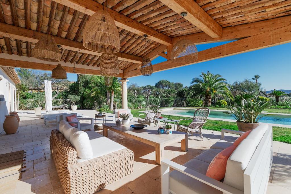 d'une terrasse avec des meubles en osier et un toit en bois. dans l'établissement Superbe Villa avec piscine -Grimaud, à Grimaud