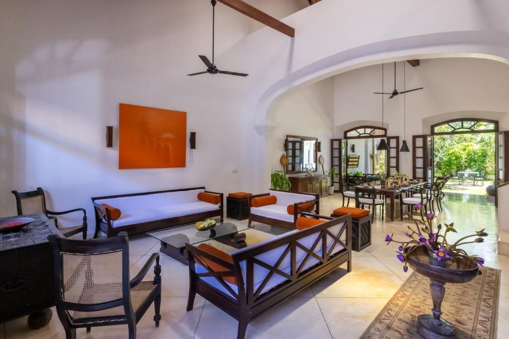 a living room with a table and chairs at Seven Pillars No 39 Galle Fort in Galle