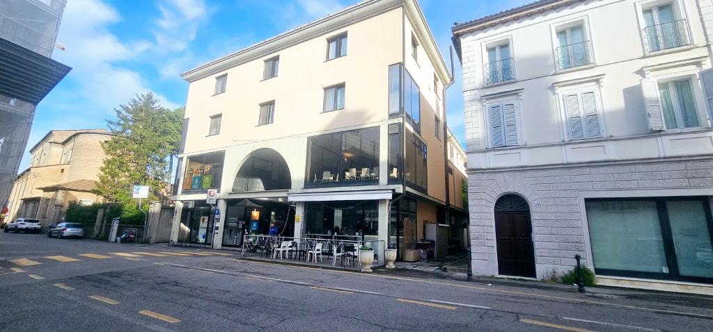 a building on a city street with a store at Porta Mazzini Central Rooms in Bagnacavallo