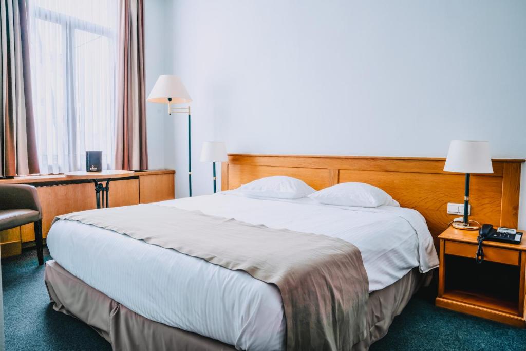 Postel nebo postele na pokoji v ubytování Hotel Les Eleveurs