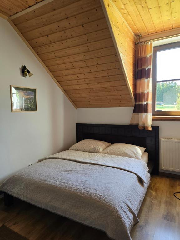 Postel nebo postele na pokoji v ubytování Grzechowisko