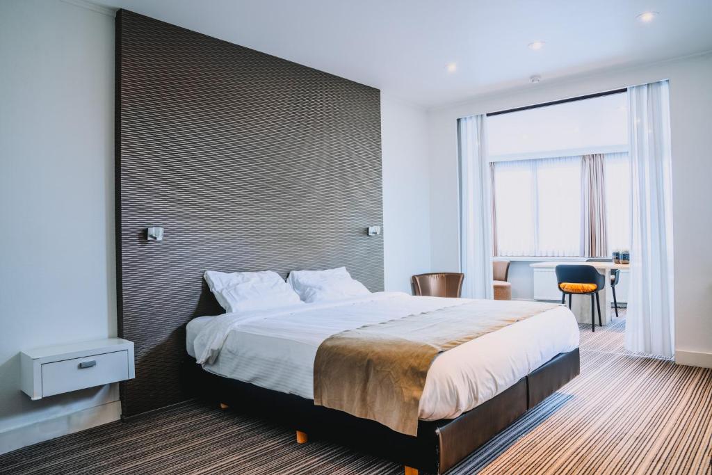 Postel nebo postele na pokoji v ubytování Hotel Les Eleveurs