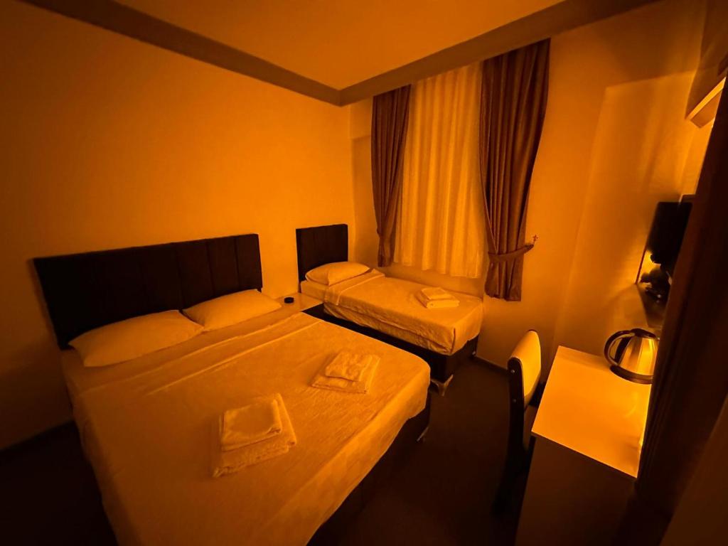 Ένα ή περισσότερα κρεβάτια σε δωμάτιο στο Ezel Group Hotel