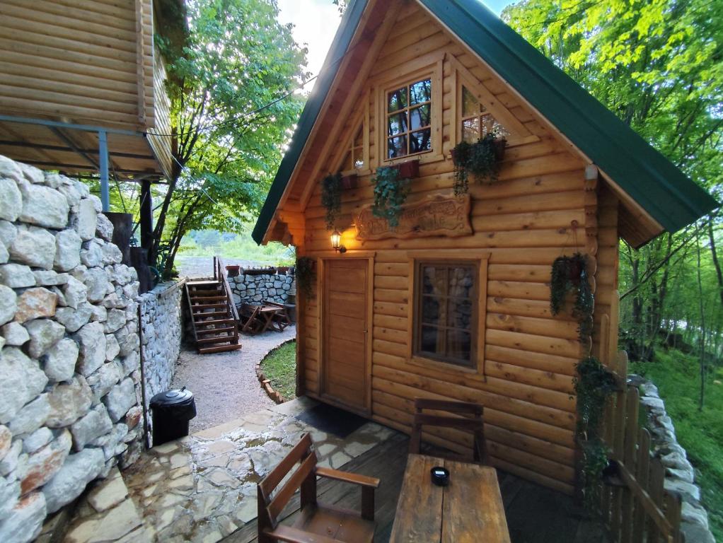 a log cabin with a bench and a table at Brvnara Fairy Tale in Cetinje