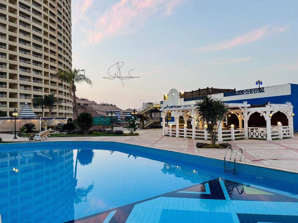 a large swimming pool in front of a building at Porto Sokhna Water Front Resort in Ain Sokhna