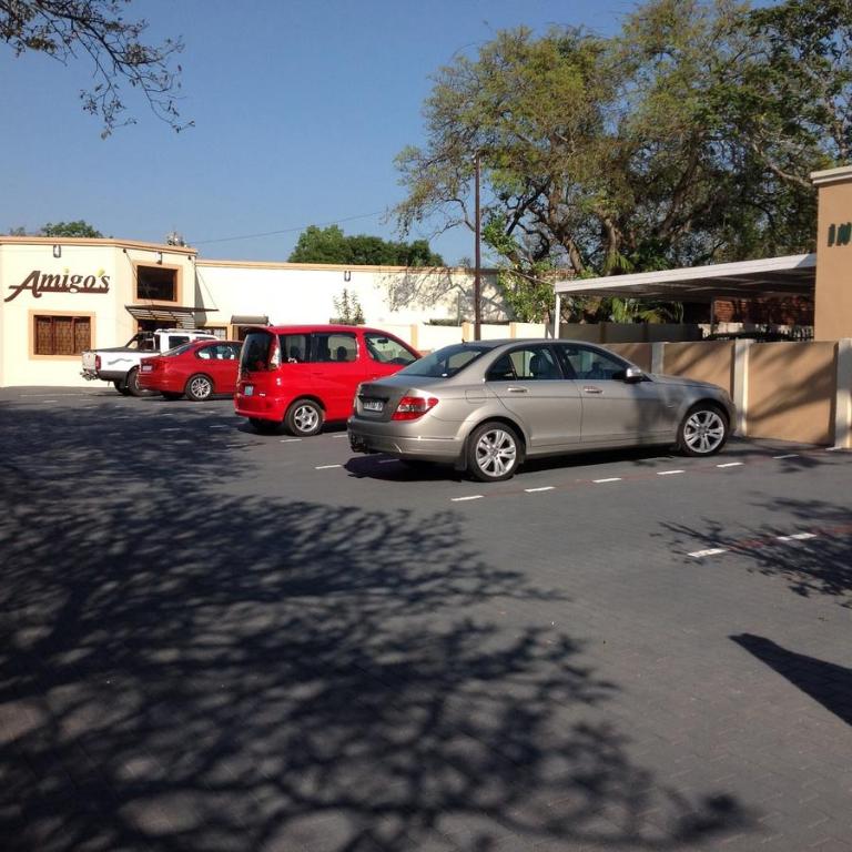 a group of cars parked in a parking lot at Amigos Bed & Breakfast - No loadshedding in Nelspruit