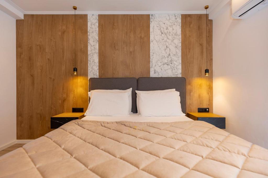 a bedroom with a large bed with two pillows at Hotel Joni in Ksamil