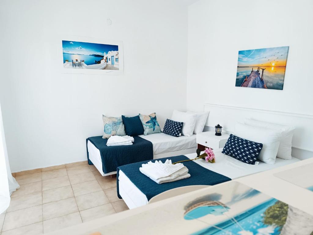 a living room with two beds and a couch at Nautilus City Studios & Apartments in Rhodes Town