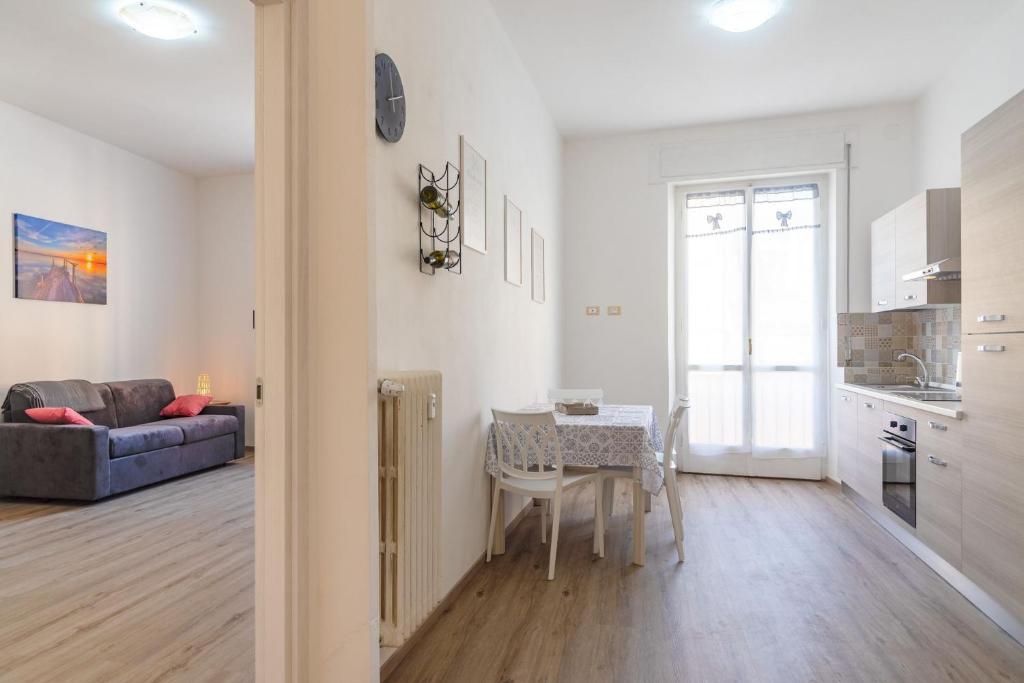 a kitchen and living room with a table and a couch at Appartamento Al Mare in Portoferraio