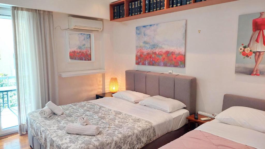 a bedroom with two beds with towels on them at Lovely apartment in Athens center in Athens