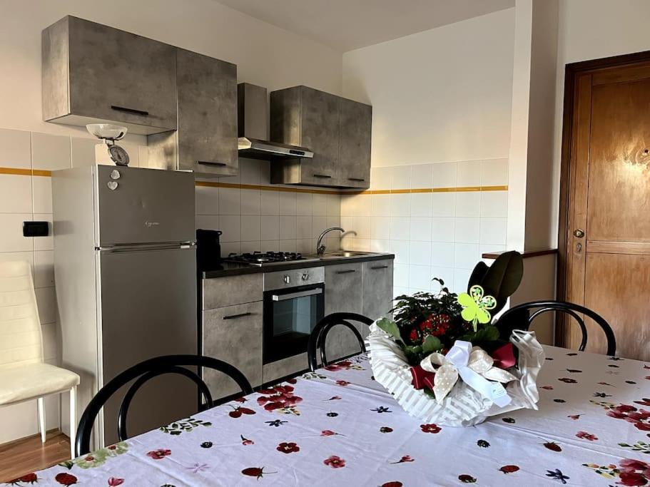 a kitchen with a table with a vase of flowers on it at Il nido dell'abete in Borgo a Buggiano