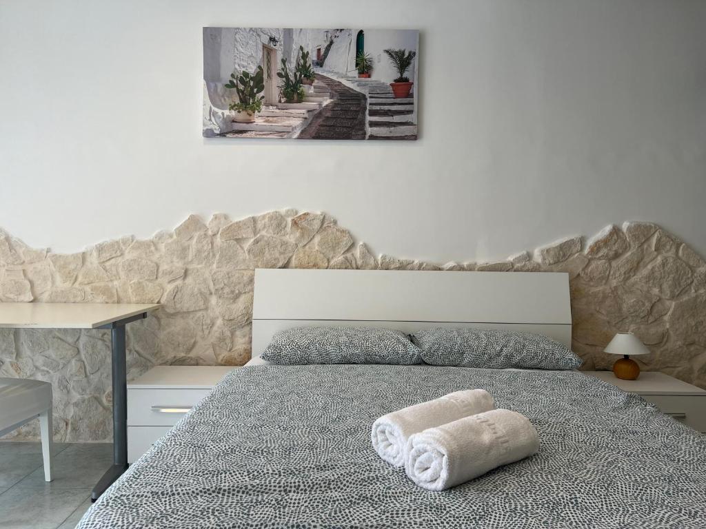 a bedroom with a bed with a towel on it at Casa Vacanze Rosie in Cellamare