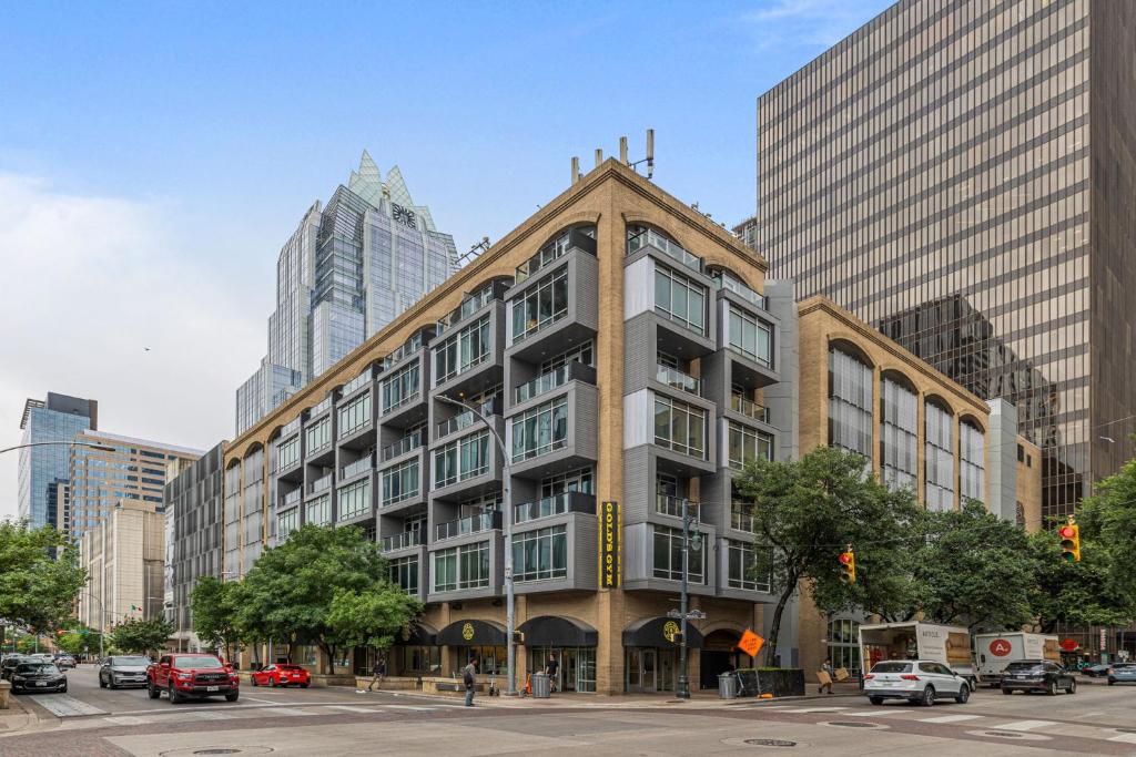 a building on a city street with tall buildings at Littlefield Lofts, Hosted by Placemakr in Austin