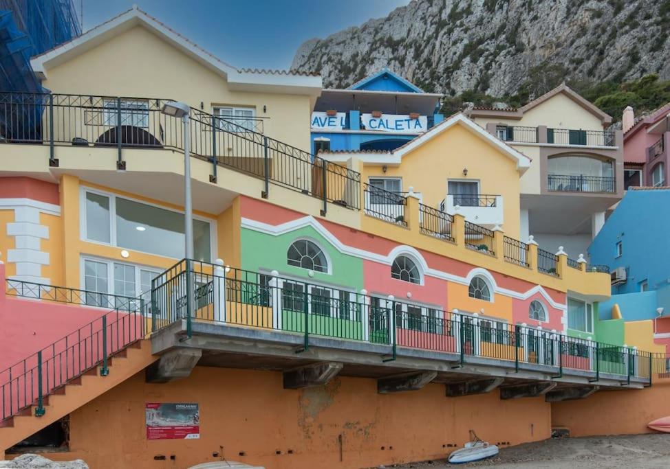 een kleurrijk gebouw met balkons aan de zijkant bij Beachfront Studio-Hosted by Sweetstay in Gibraltar