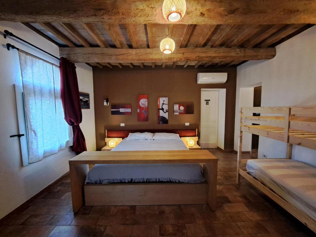 Postel nebo postele na pokoji v ubytování B&B Ca Rossa
