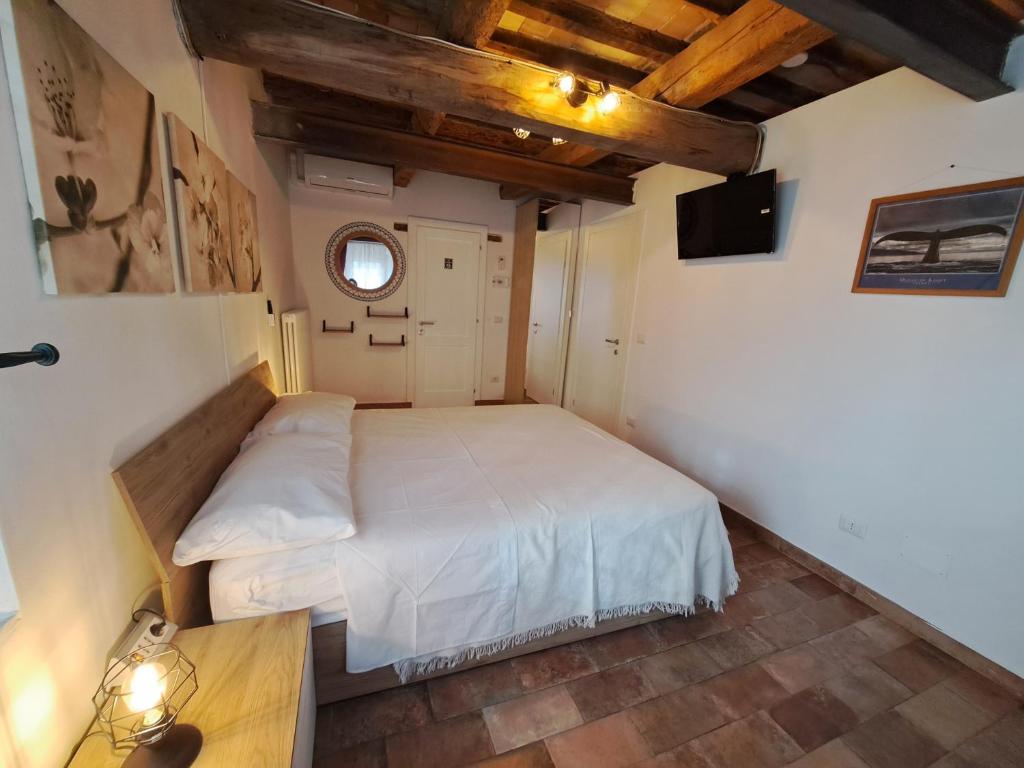Postel nebo postele na pokoji v ubytování B&B Ca Rossa