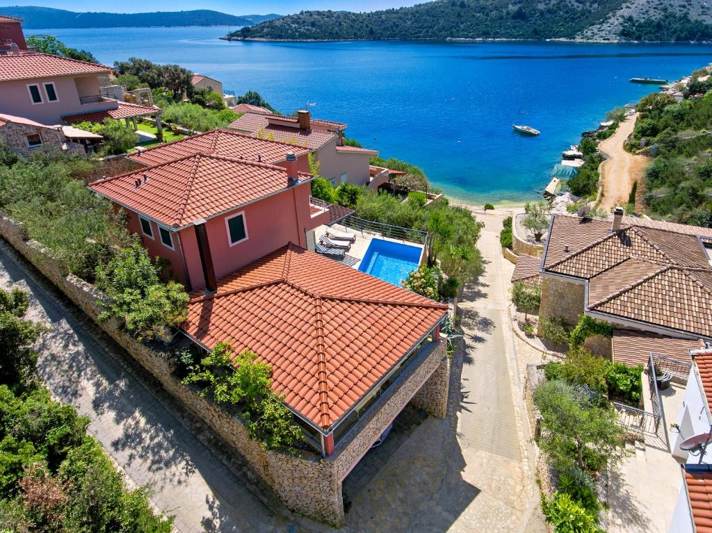 an aerial view of a house and the water at Beachfront Vila Angelina in Vinišće