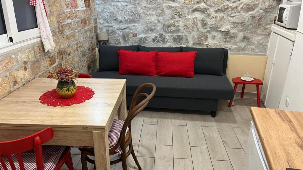 a living room with a couch and a table with red pillows at Apartment Kova in Split