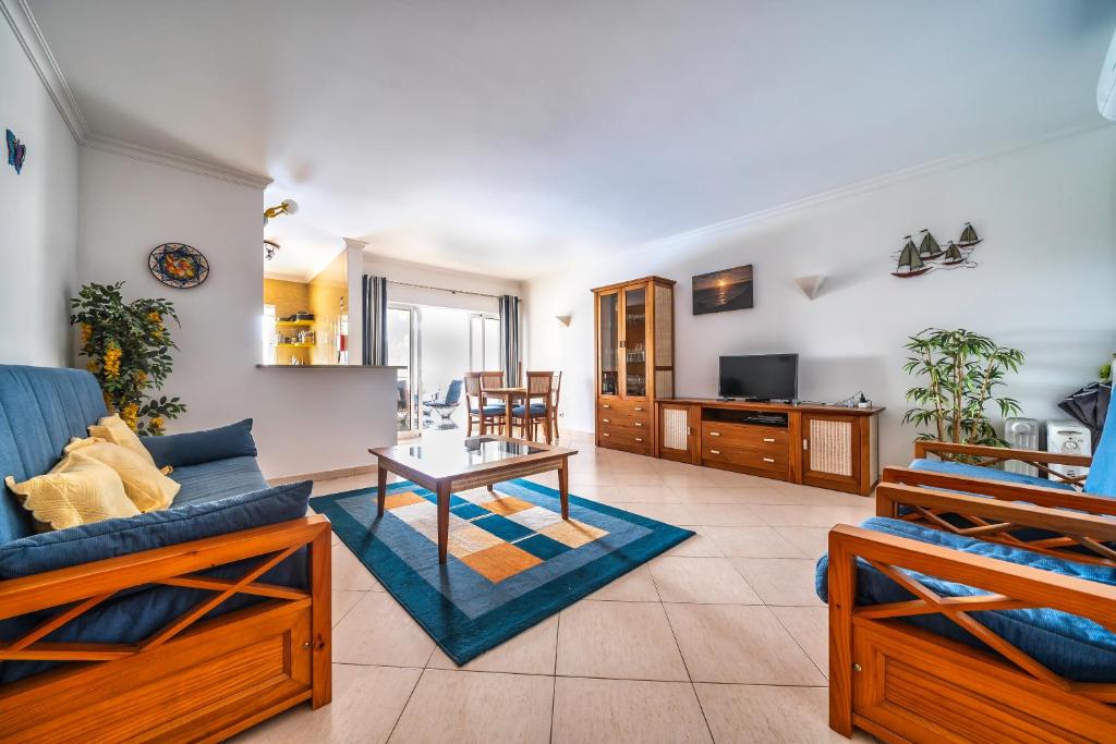 a living room with a couch and a table at Close to beach Alvor 1 bedroom apartment Villa da Praia AT08 in Alvor